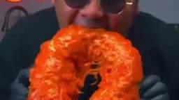 Paul Buhl eats a giant spaghetti sausage roll on his birthday